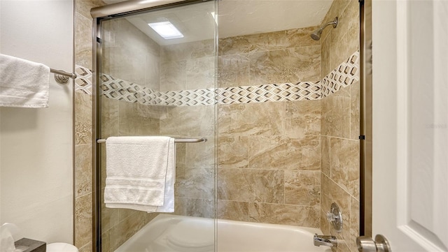 bathroom featuring shower / bath combination with glass door