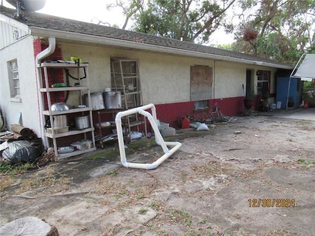 1814 6th Ave E, Bradenton, FL 34208 - back of house with stucco siding and a shingled roof