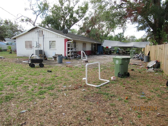 rear view of house featuring central air condition unit