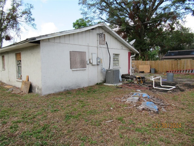 view of side of home featuring central AC