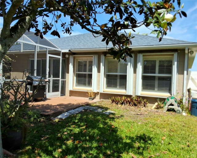 5115 44th St W, Bradenton, FL 34210 - rear view of house featuring a patio area, a lawn, a shingled roof, and a lanai