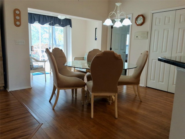 5115 44th St W, Bradenton, FL 34210 - dining area featuring baseboards, wood finished floors, and a chandelier