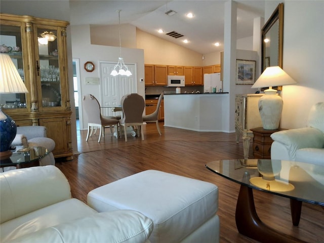 5115 44th St W, Bradenton, FL 34210 - living room with high vaulted ceiling, dark wood-style floors, a chandelier, and visible vents