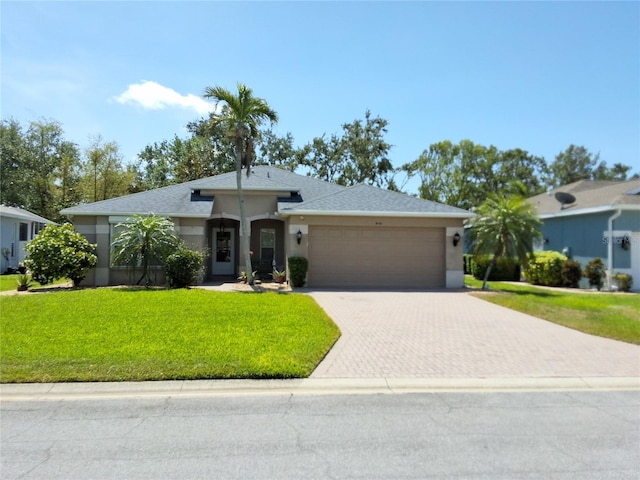 5115 44th St W, Bradenton, FL 34210 - single story home featuring roof with shingles, an attached garage, a front yard, stucco siding, and decorative driveway