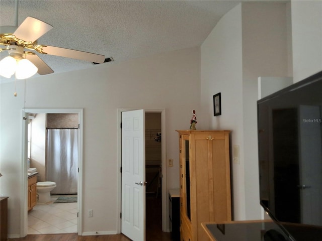 5115 44th St W, Bradenton, FL 34210 - bedroom featuring a spacious closet, visible vents, ensuite bath, a textured ceiling, and ceiling fan