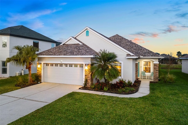 view of front facade with a lawn and a garage