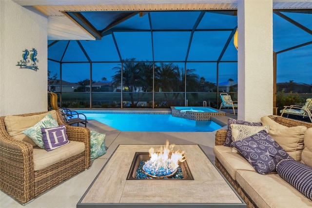 view of pool featuring a patio, glass enclosure, an in ground hot tub, and an outdoor fire pit