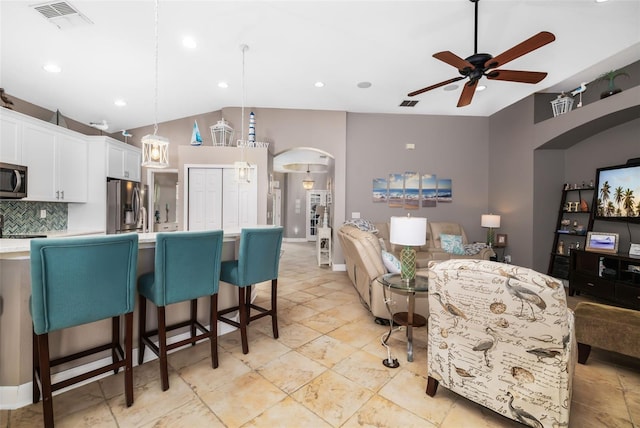 interior space featuring ceiling fan and lofted ceiling