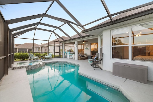 view of swimming pool featuring glass enclosure, an outdoor hangout area, ceiling fan, an in ground hot tub, and a patio