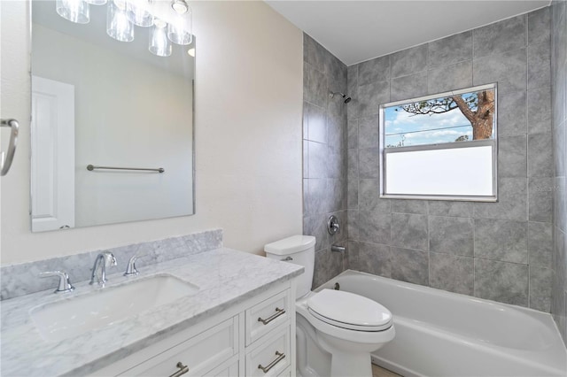 full bathroom with tiled shower / bath combo, toilet, and vanity