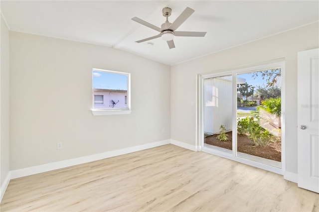 empty room with ceiling fan, light hardwood / wood-style floors, and vaulted ceiling