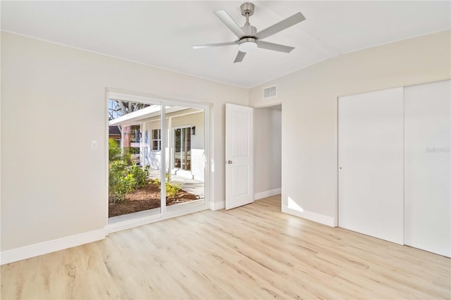 unfurnished bedroom featuring access to outside, multiple windows, ceiling fan, and light hardwood / wood-style flooring