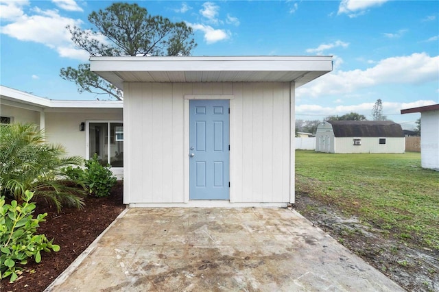 view of outdoor structure featuring a lawn