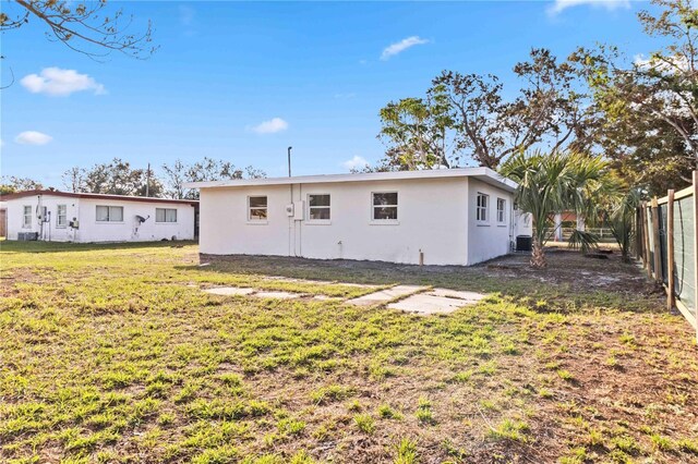 rear view of property with a yard