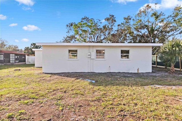 back of property featuring a lawn