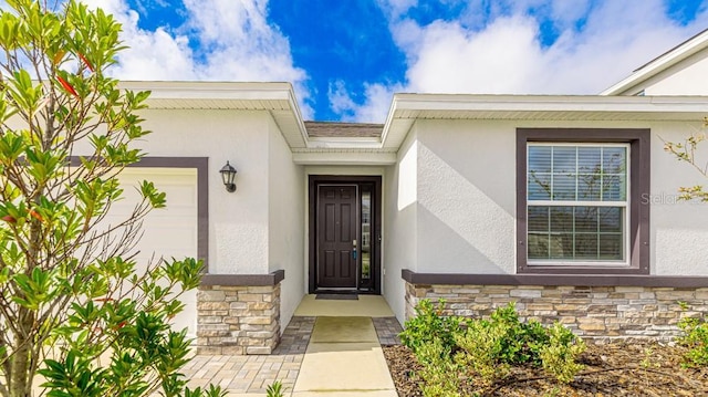 view of exterior entry with a garage