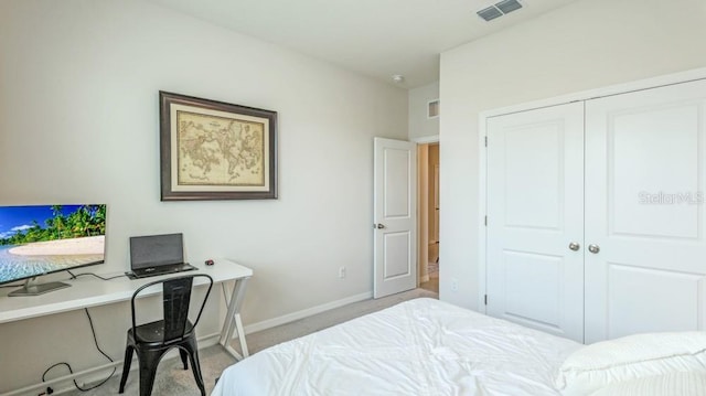 bedroom featuring light carpet and a closet