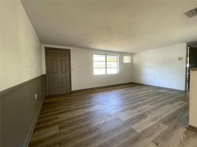 unfurnished room featuring hardwood / wood-style flooring