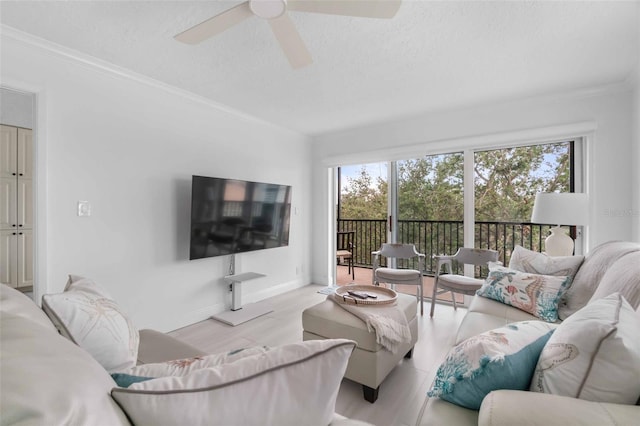 living room featuring crown molding and ceiling fan