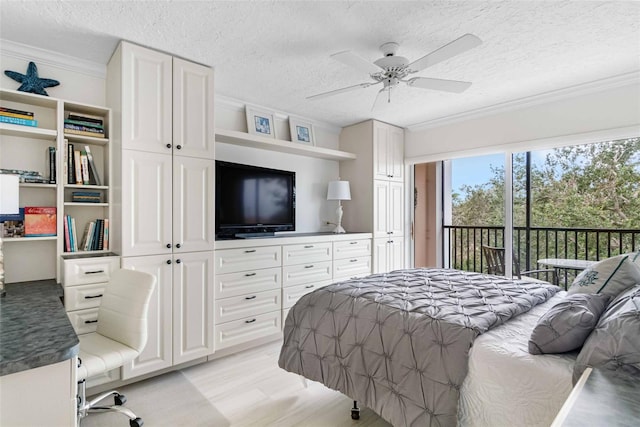 bedroom featuring ceiling fan, ornamental molding, access to exterior, and a textured ceiling