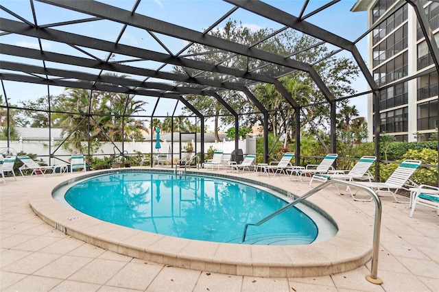 view of pool featuring a patio and glass enclosure