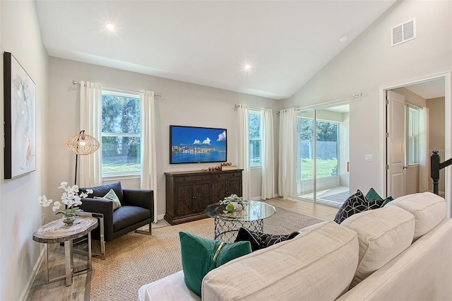 living room featuring light hardwood / wood-style floors and vaulted ceiling