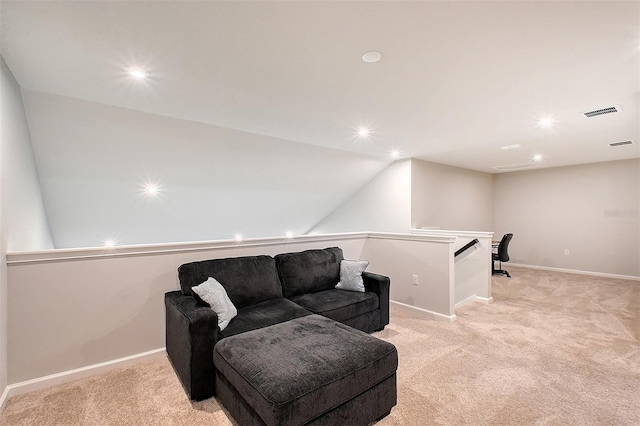 sitting room featuring light colored carpet and lofted ceiling