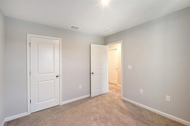 unfurnished bedroom with light colored carpet