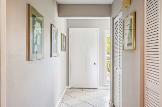 hallway with light tile patterned floors and a wealth of natural light