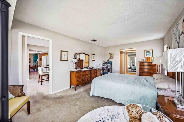 carpeted bedroom featuring a textured ceiling