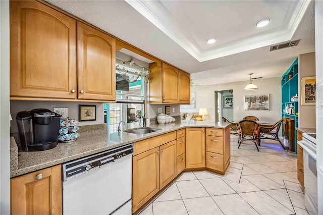 kitchen featuring kitchen peninsula, stove, white dishwasher, a raised ceiling, and crown molding