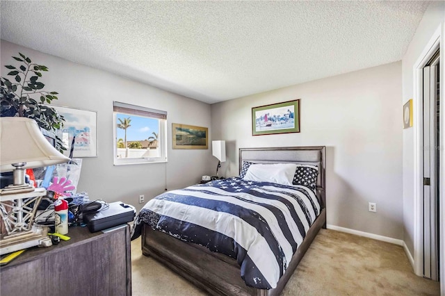 bedroom with light carpet and a textured ceiling