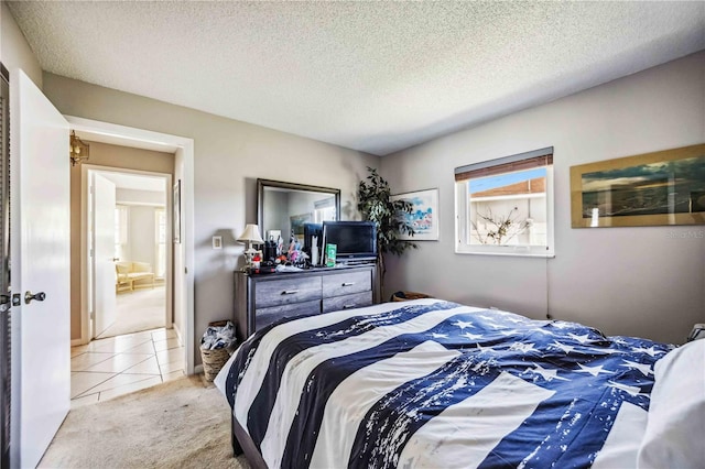 bedroom featuring light carpet and a textured ceiling