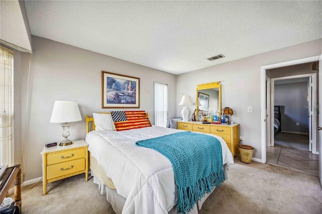 carpeted bedroom featuring a textured ceiling