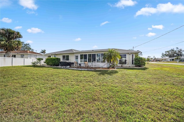 back of property featuring a lawn