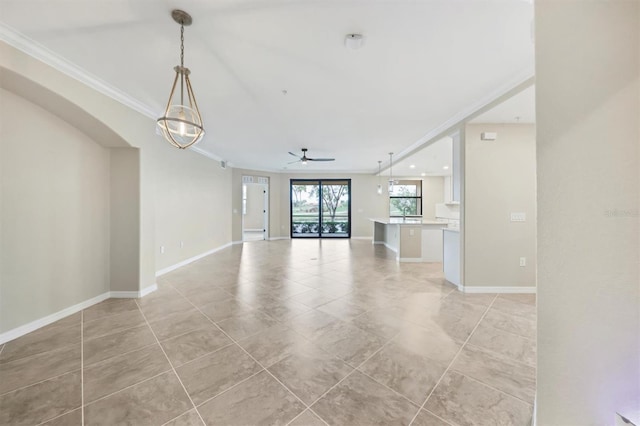 unfurnished living room with crown molding, ceiling fan, and light tile patterned floors