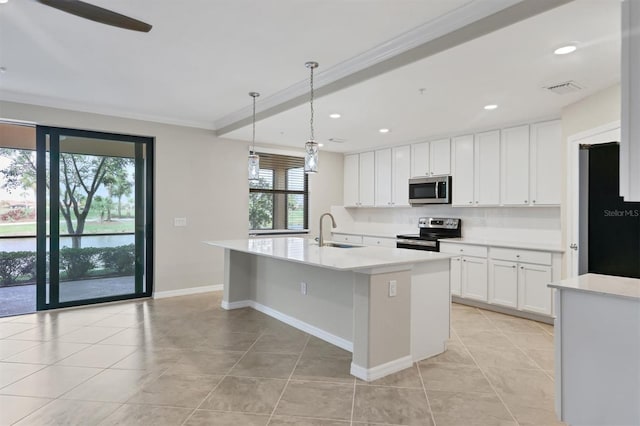 kitchen with stainless steel appliances, decorative light fixtures, an island with sink, and white cabinets