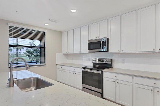 kitchen with white cabinetry, sink, and stainless steel appliances