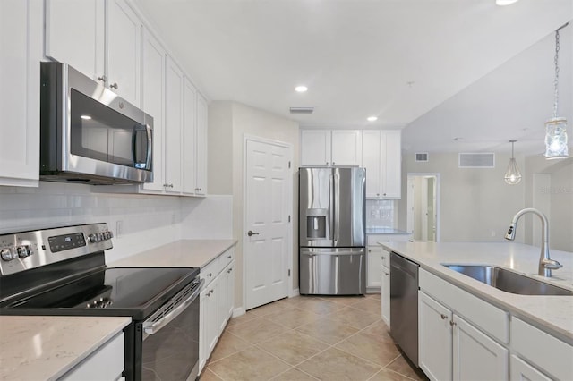 kitchen with white cabinetry, sink, stainless steel appliances, and hanging light fixtures