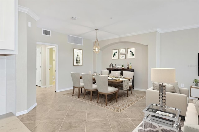 tiled dining area featuring ornamental molding