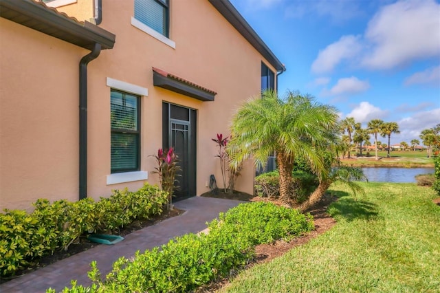 doorway to property featuring a yard