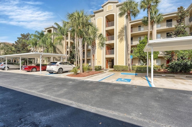 view of property with covered and uncovered parking