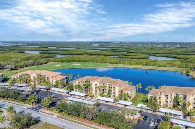 drone / aerial view featuring a residential view and a water view