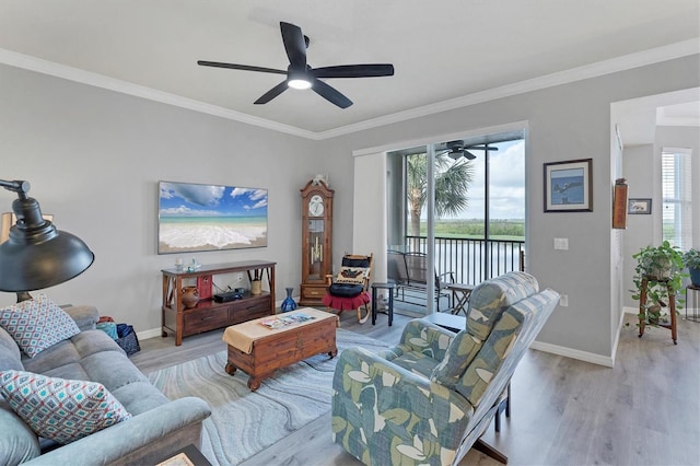 living area featuring light wood finished floors, plenty of natural light, and crown molding