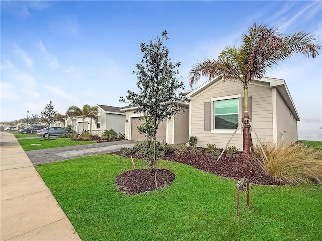 view of front of home with a garage and a front yard