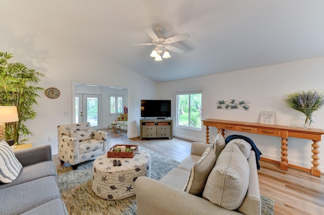 living room featuring light wood-type flooring, ceiling fan, and lofted ceiling