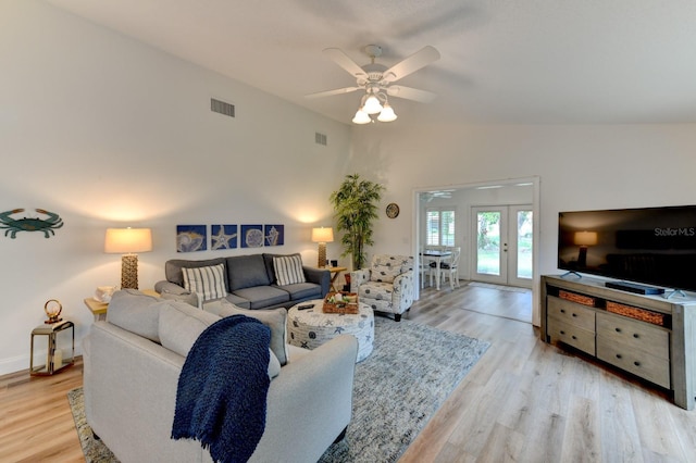 living room featuring french doors, light hardwood / wood-style floors, vaulted ceiling, and ceiling fan