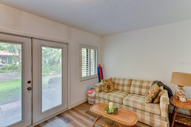 living room featuring french doors and light wood-type flooring