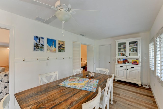 dining room with light hardwood / wood-style flooring and ceiling fan