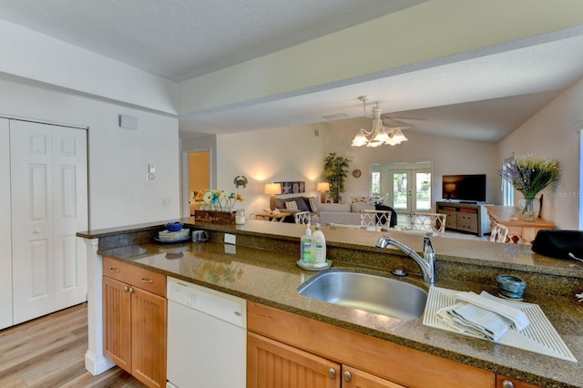 kitchen with dishwasher, french doors, sink, light wood-type flooring, and a notable chandelier